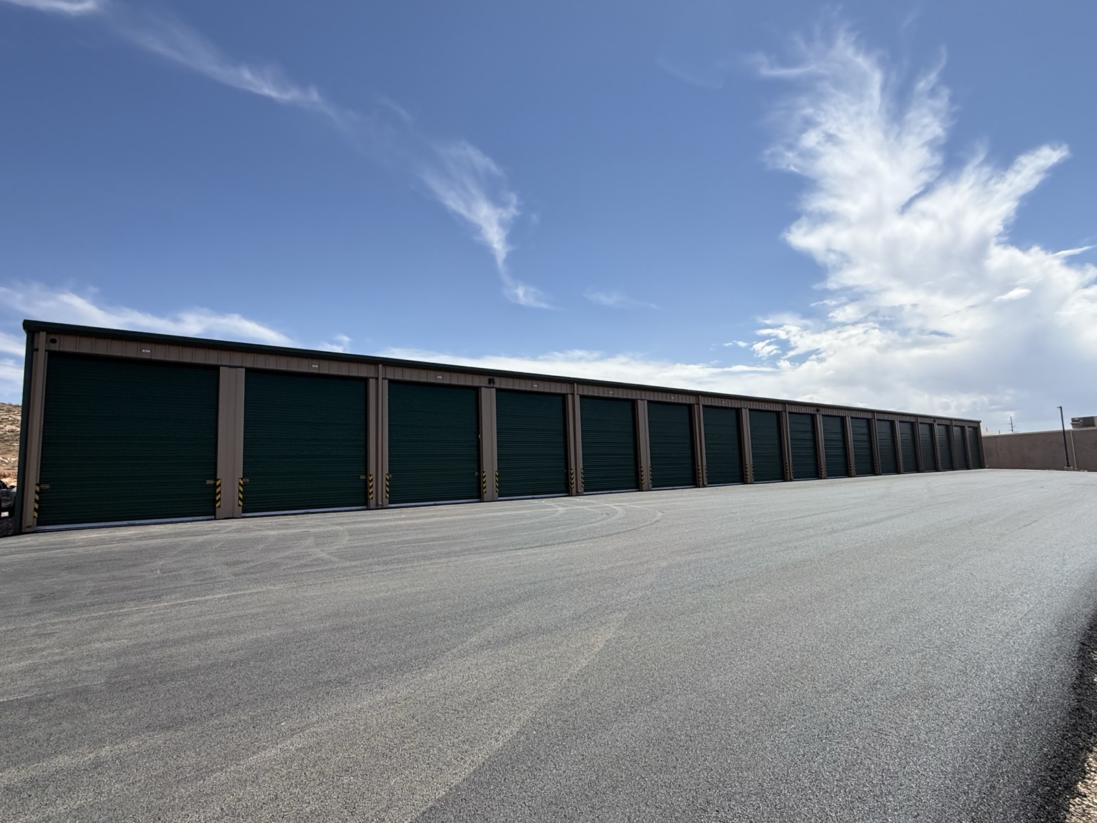 Long row of brand-new drive-through units with green doors